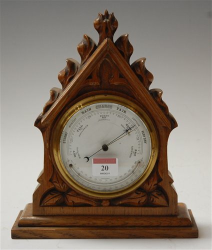 Lot 20 - A late Victorian carved oak cased barometer,...