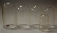 Lot 40 - Five various graduated glass clock domes, the...
