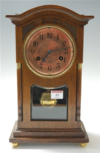 Lot 42 - A late 19th century carved oak mantel clock,...