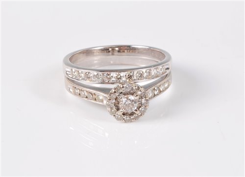 Lot 2518 - An 18ct white gold diamond halo ring and...