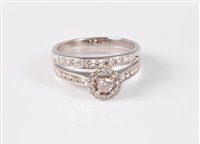 Lot 379 - An 18ct white gold diamond halo ring and...