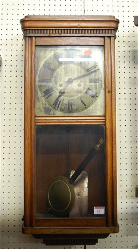 Lot 107 - A 1930s oak cased wall clock having a silvered...