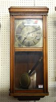 Lot 107 - A 1930s oak cased wall clock having a silvered...