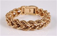 Lot 1195 - A 9ct rope twist bracelet, the the two double...