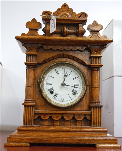 Lot 127 - A late 19th century oak cased mantel clock...