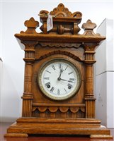 Lot 127 - A late 19th century oak cased mantel clock...
