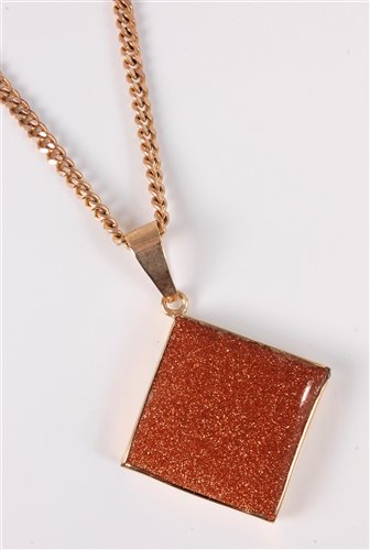 Lot 2506 - A goldstone pendant and 9ct chain, the square...