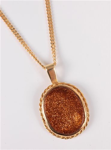 Lot 2505 - A goldstone pendant and 18ct chain, the oval...