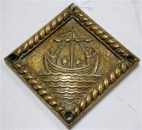 Lot 164 - A small brass plaque of square form, relief...
