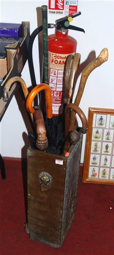 Lot 670 - An antique brass stick stand, containing a...