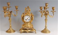 Lot 1502 - A Rococo Revival gilt metal three-piece clock...