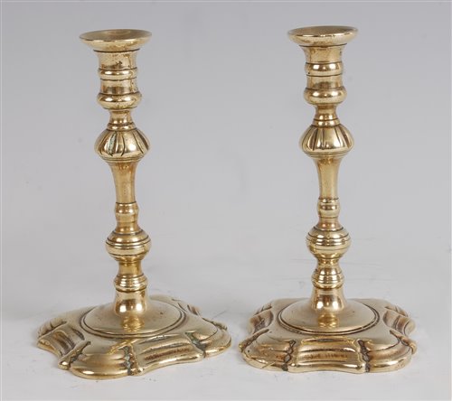 Lot 1257 - A pair of mid-18th century brass taper sticks,...