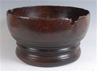 Lot 1293 - A turned elm bowl, of good size, raised on...
