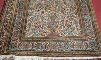 Lot 1558 - A Kashmiri hand-knotted silk rug, the cream...