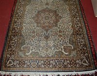 Lot 1559 - A Kashmiri hand-knotted silk rug, the cream...