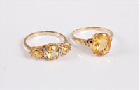 Lot 2663 - A 9ct three stone citrine and diamond ring and...