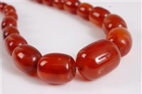 Lot 354 - A faux amber necklace, the graduated oval...