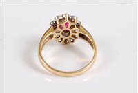 Lot 2625 - An 18ct ruby and diamond ring, the oval ruby...