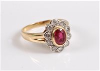 Lot 2625 - An 18ct ruby and diamond ring, the oval ruby...
