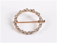 Lot 2593 - A diamond wreath brooch, the wreath set with...