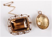 Lot 2659 - A citrine brooch and a citrine pendant, the...
