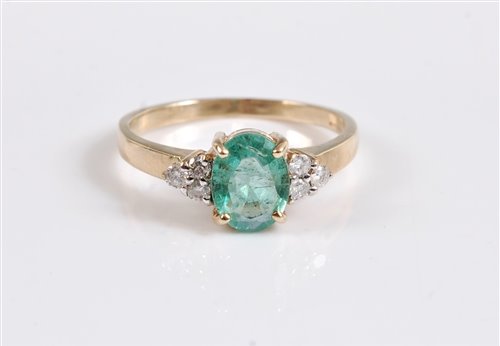 Lot 2650 - A 9ct emerald and diamond ring, the oval pale...