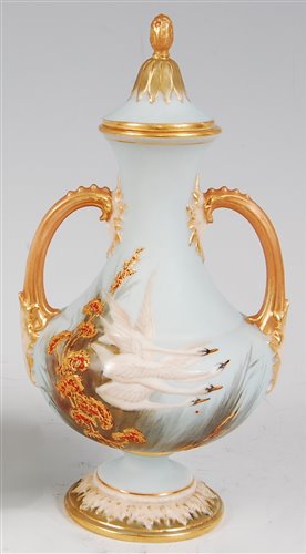 Lot 1039 - *A Royal Worcester twin handled vase and cover,...