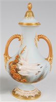Lot 1039 - *A Royal Worcester twin handled vase and cover,...