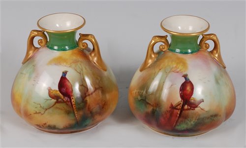 Lot 1040 - *A pair of Royal Worcester twin handled...