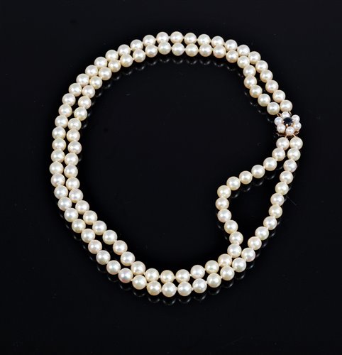 Lot 2584 - A two strand cultured pearl necklace, the two...