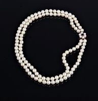 Lot 2584 - A two strand cultured pearl necklace, the two...