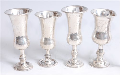 Lot 1108 - *A set of three Edwardian silver kiddush cups,...