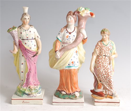 Lot 1090 - A 19th century Staffordshire figure of a lady,...