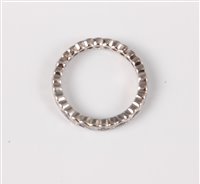 Lot 2575 - A black and white diamond eternity ring, the...