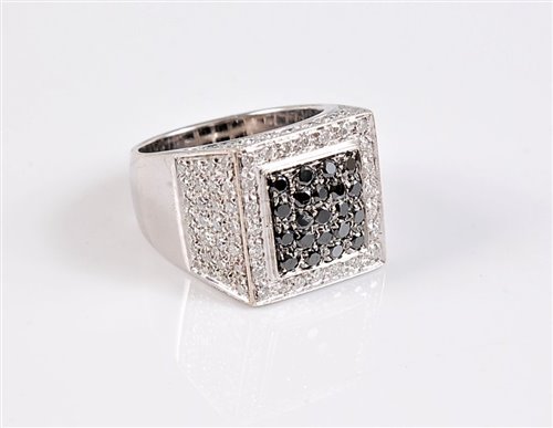 Lot 1202 - An 18ct black and white diamond ring, the...