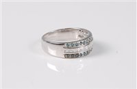 Lot 1204 - A blue and white diamond half hoop ring, the...