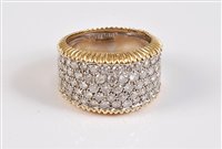 Lot 1203 - A bi-coloured 18ct diamond ring, the 12mm wide...