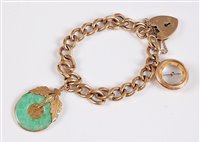 Lot 1175 - A 9ct charm bracelet, the flat curblink...