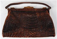 Lot 172 - An early 20th century crocodile skin clutch...