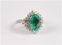 Lot 1217 - An 18ct and platinum emerald and diamond ring,...