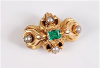 Lot 1181 - An emerald and pearl brooch, the central...