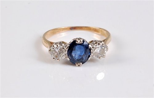 Lot 1171 - An 18ct sapphire and diamond ring, the central...