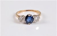 Lot 1171 - An 18ct sapphire and diamond ring, the central...