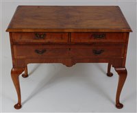 Lot 1607 - A walnut lowboy, in the 18th century style,...