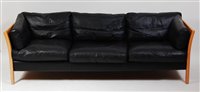 Lot 410 - A 1980s Danish black leather three-seater sofa...