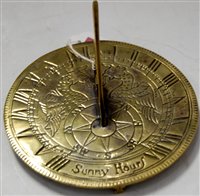 Lot 29 - A brass sundial of typical form engraved with...