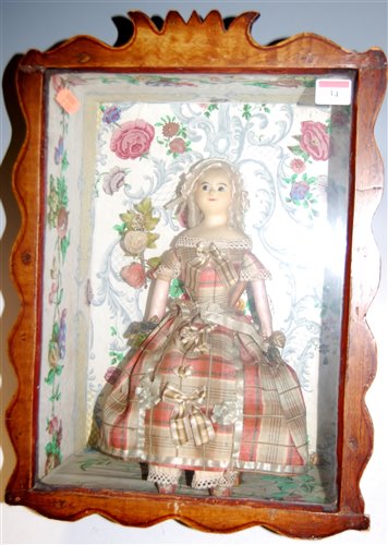 Lot 34 - A 19th century wax head doll having beaded...