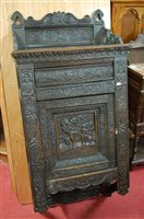 Lot 1138 - A joined and heavily relief carved oak single...