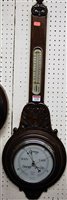 Lot 1158 - A 1930s relief carved oak two dial aneroid...