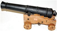 Lot 97 - A cast iron model of a canon on oak base,...